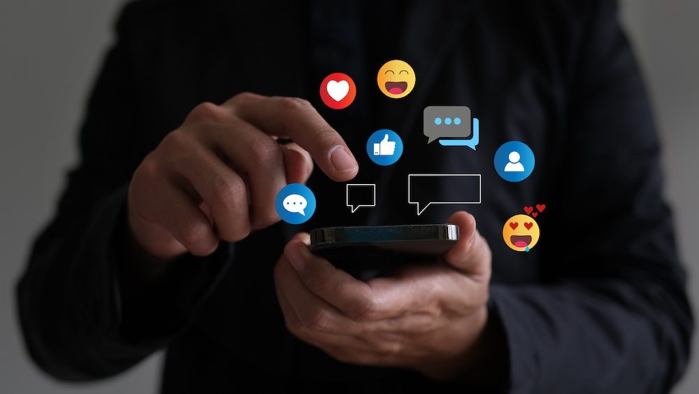 Social media interaction phone concept, man replying to comments Show how you feel over the smartphone.