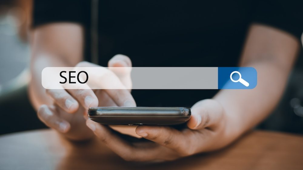 Searching Engine Optimizing SEO Browsing Concept, Businessman holding phone for looking information with technology and internet icon